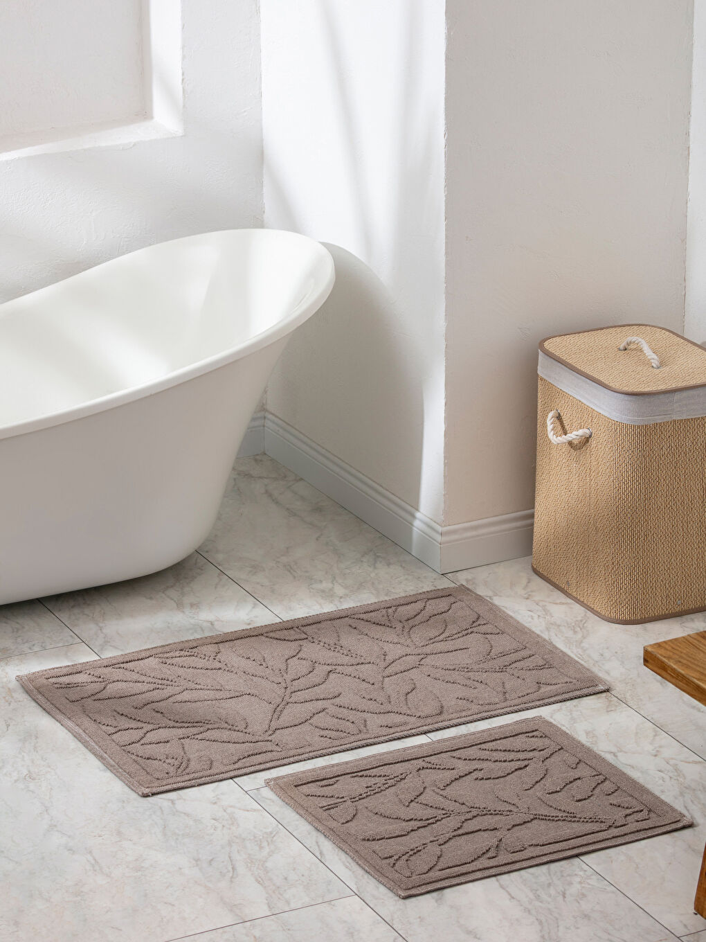 A set of two patterned bath mats.