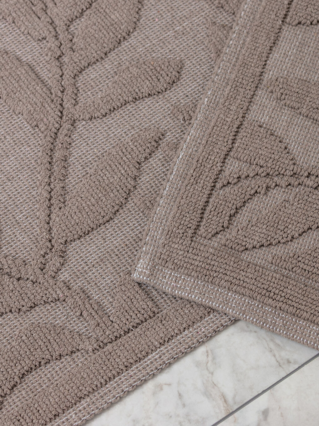 A set of two patterned bath mats.-1