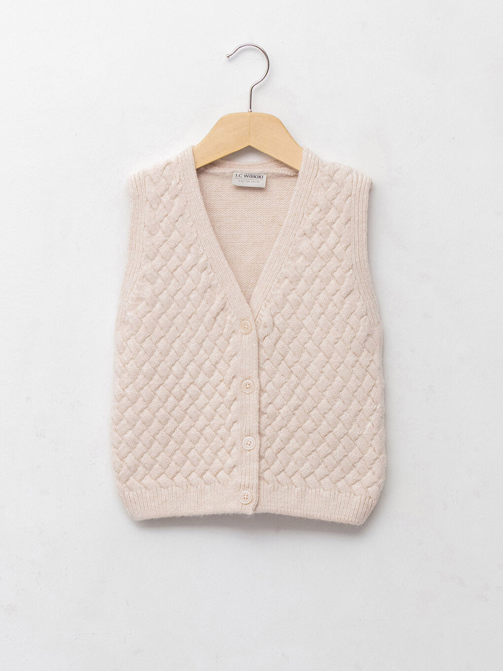 Pleteni prsluk za devojčice sa V izrezom i dezenom