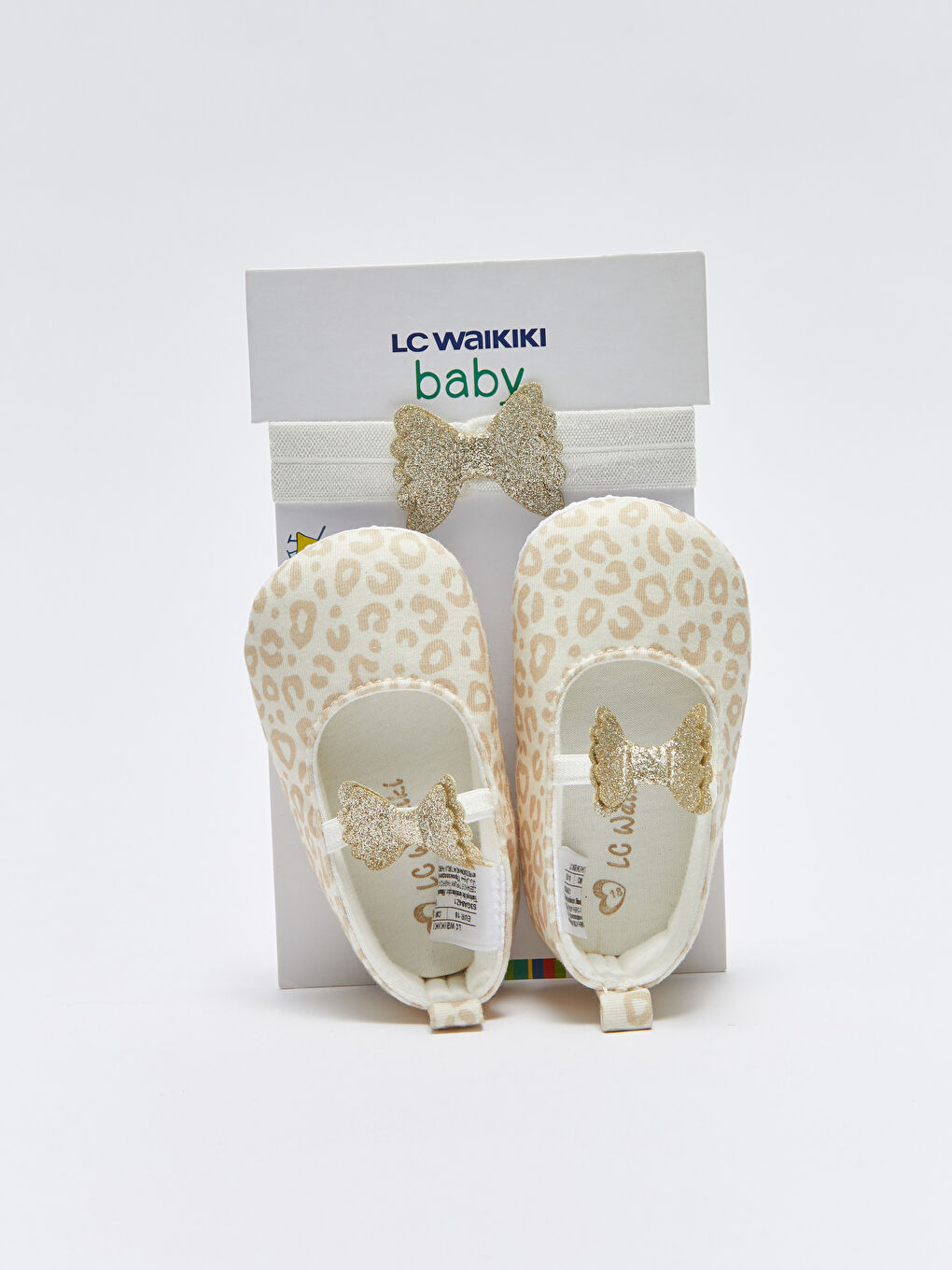 ბაფთით დეტალური გოგონას პირველი ნაბიჯების ფეხსაცმელი და თმის სამაგრი