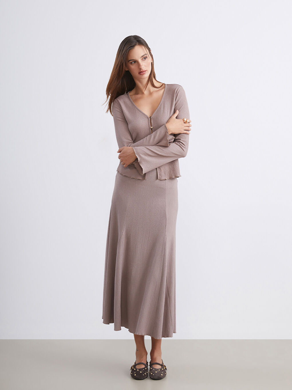 Bej Beli Lastikli Dokulu Pileli Etek