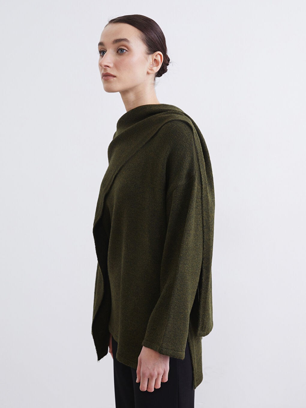 Effortlessly chic: the oversized knit sweater with a draped shawl collar.
