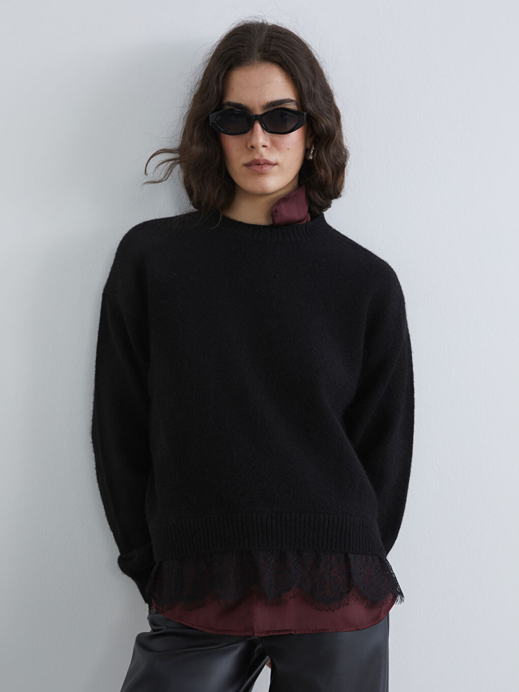 Elevate your style with our crew neck knit sweater, delicately detailed with lace.