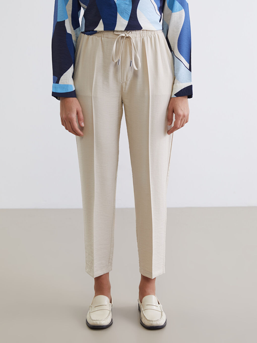 Effortless style meets all-day comfort in our Carrot Fit Trousers, designed with a flattering silhouette and an easy elasticated waist.-1