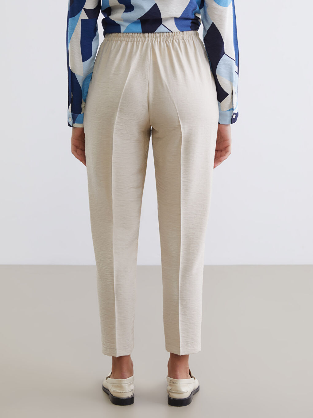 Effortless style meets all-day comfort in our Carrot Fit Trousers, designed with a flattering silhouette and an easy elasticated waist.-3