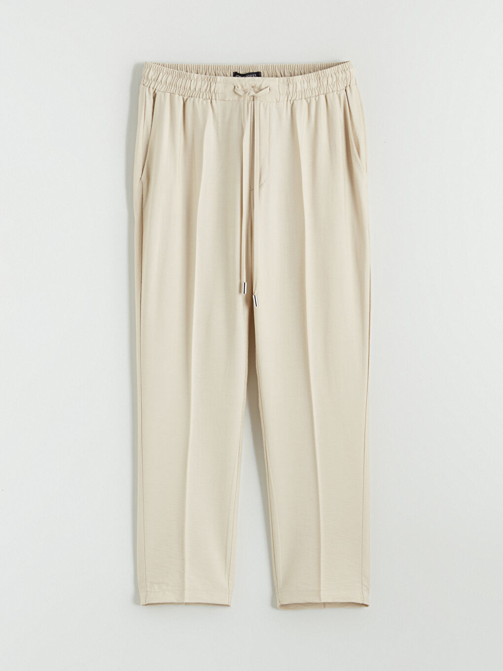 Effortless style meets all-day comfort in our Carrot Fit Trousers, designed with a flattering silhouette and an easy elasticated waist.-4