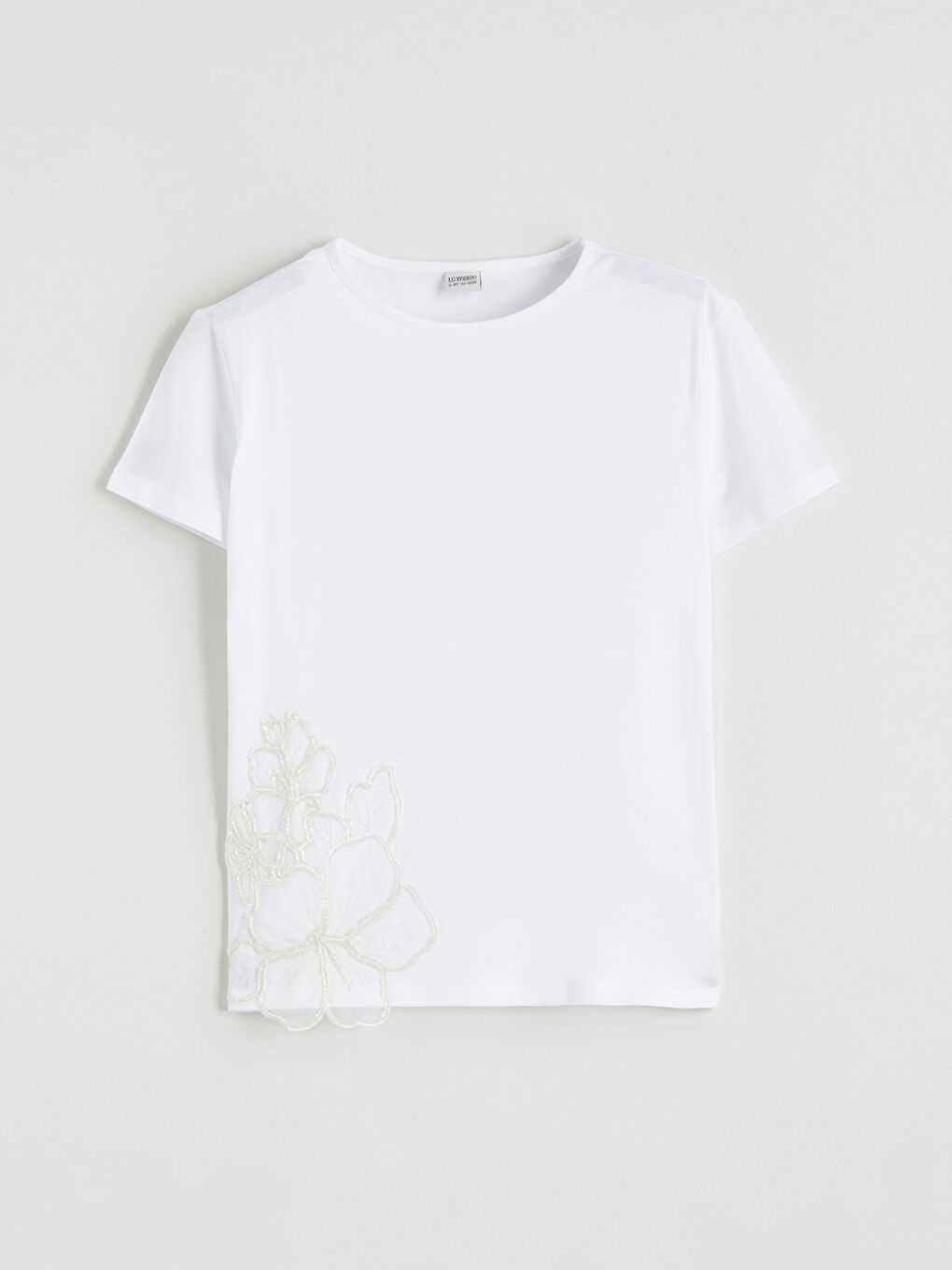 Girls' T-shirt with floral detailing.