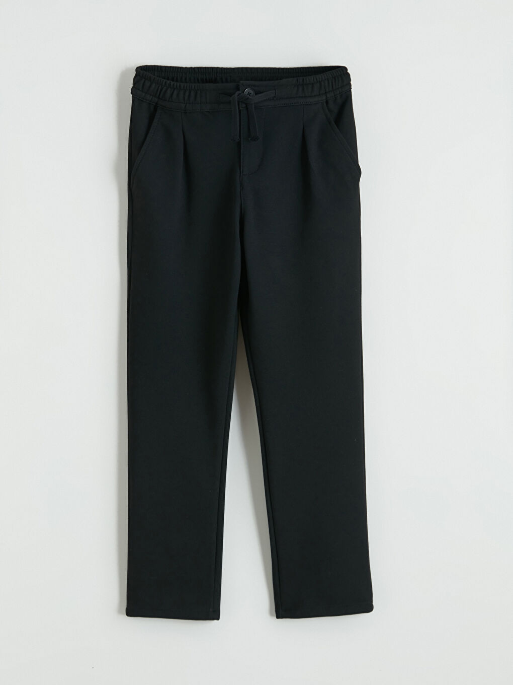 Boys' pleated trousers with elasticated waist.