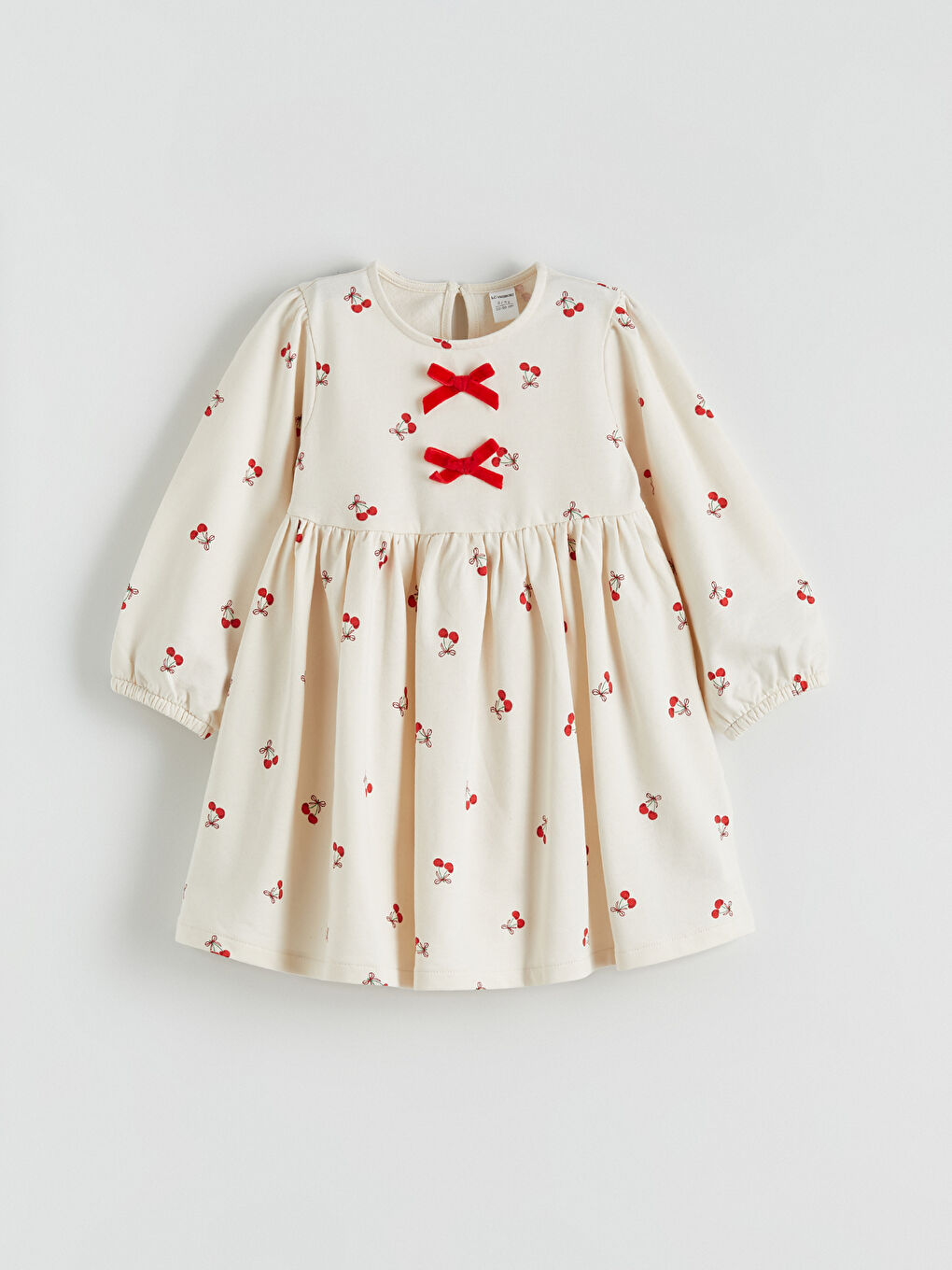 Girls' dress with a bicycle collar and bow.