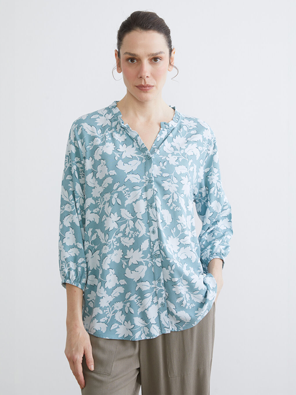 Floral blouse with an asymmetrical neckline.