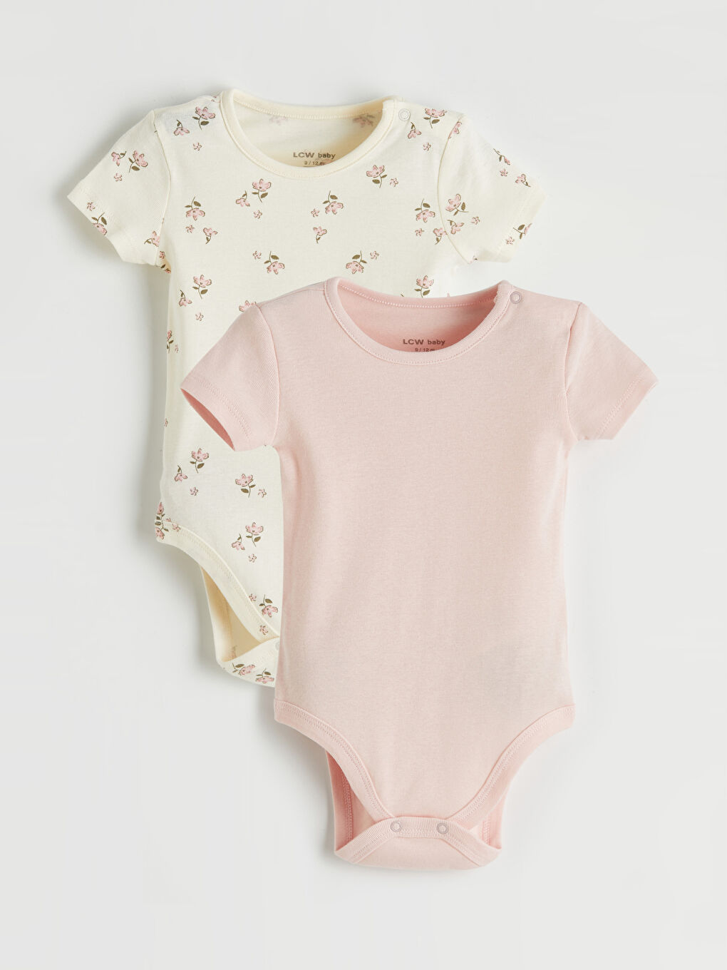 Two-piece snap-closure bodysuit set for baby girls with a crew neck.