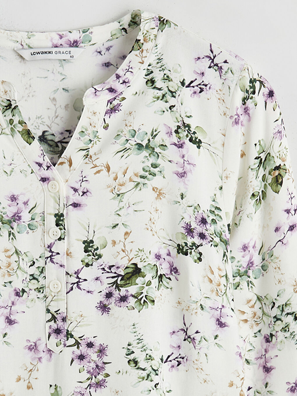 Floral blouse with an asymmetrical neckline.-5