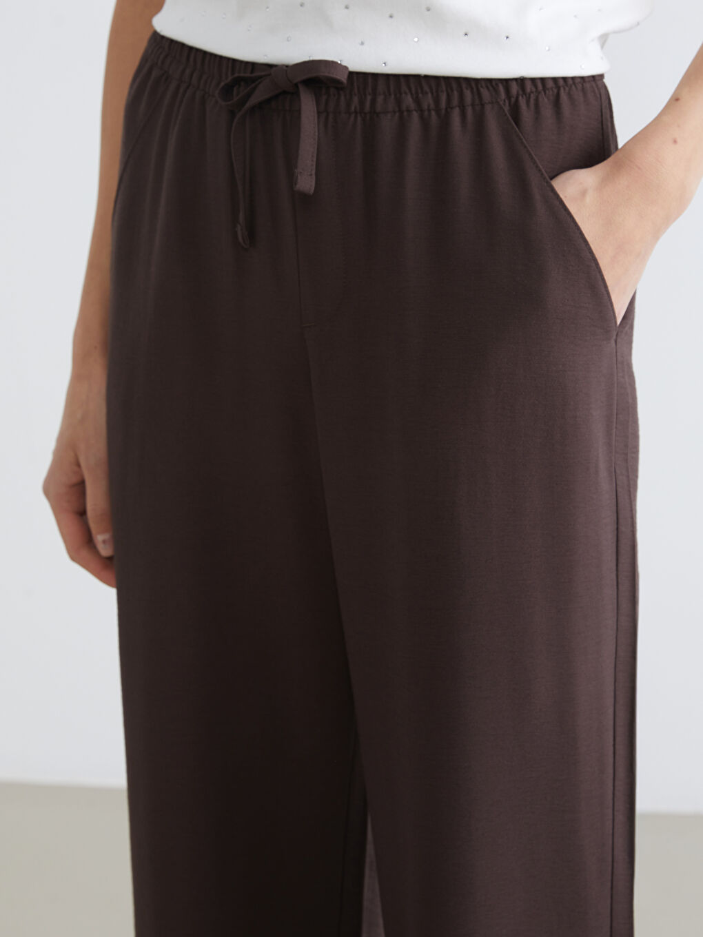 Bezvremenska elegancija susreće svakodnevnu udobnost u našim pantalonama širokih nogavica sa elastičnim pojasom.-2