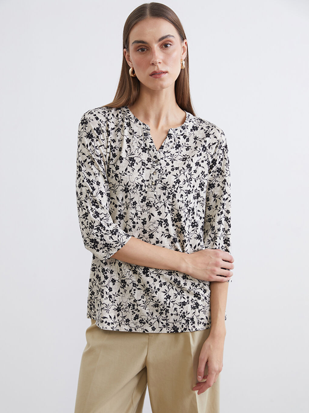 Floral blouse with an asymmetrical neckline.