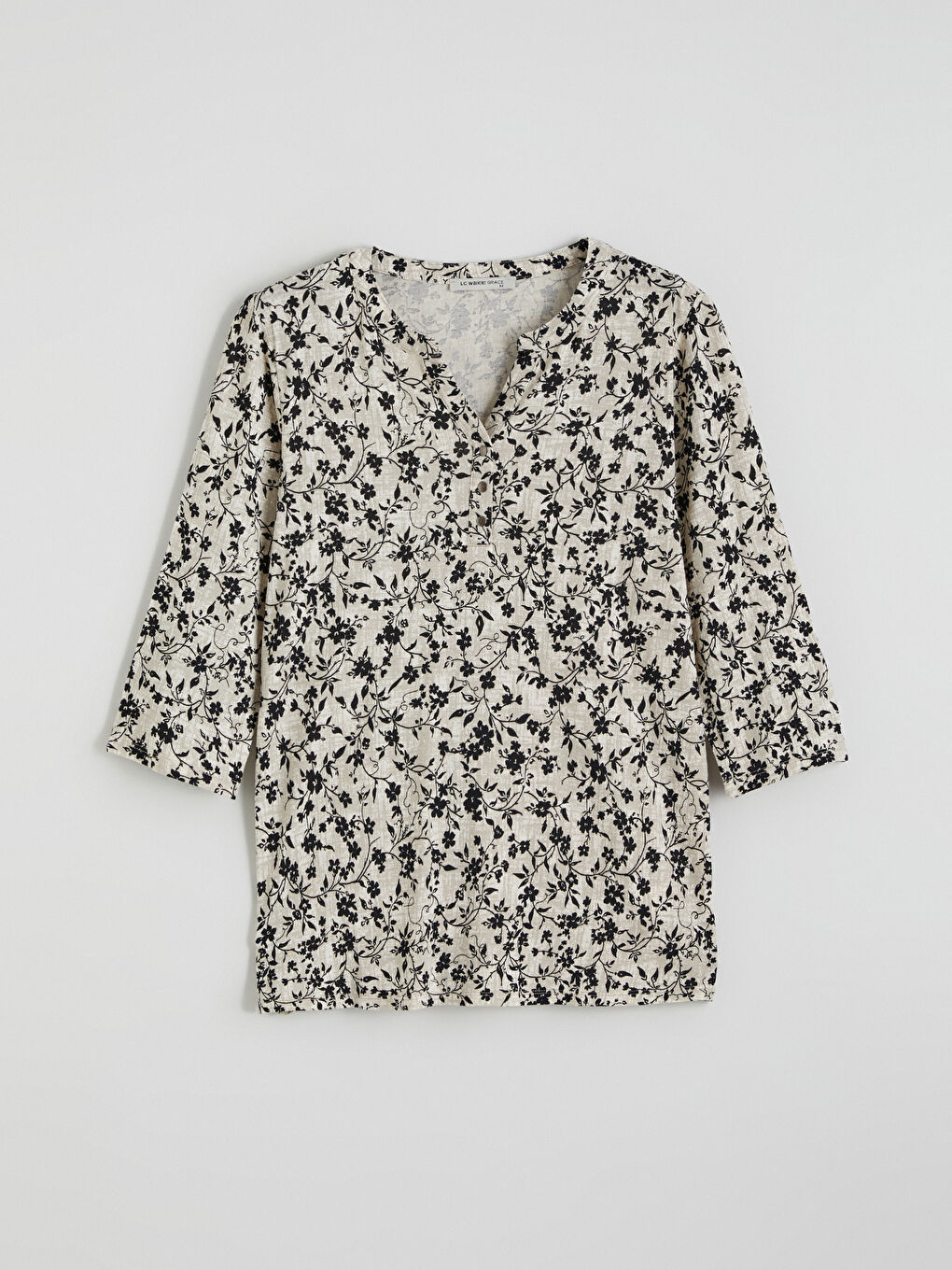 Floral blouse with an asymmetrical neckline.-4