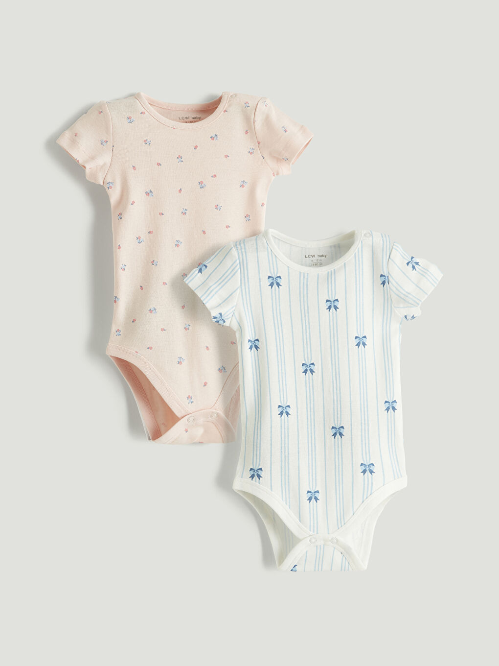 Two-piece baby girl printed snap-closure bodysuit set.
