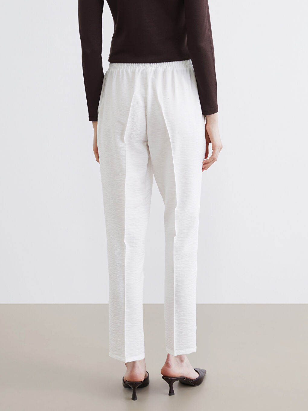 Effortless style meets everyday comfort in our Carrot Fit Trousers, designed with a flattering elasticated waist.-3