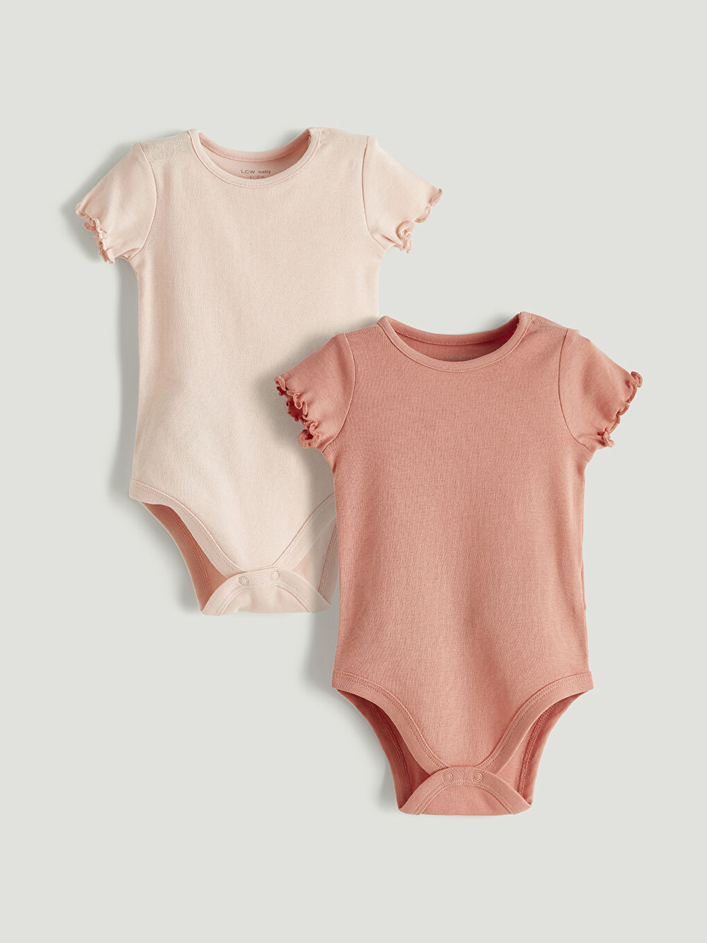 Two-piece ruffled baby girl snap-closure bodysuit.