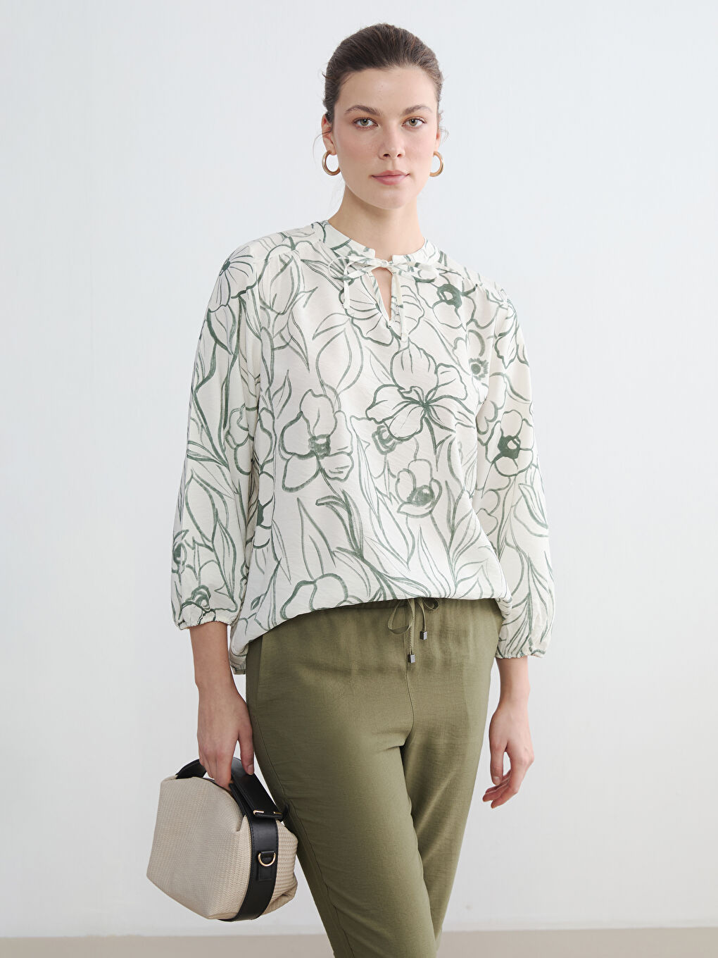 بلوزة نسائية مزينة بربطة عنق مزهرة