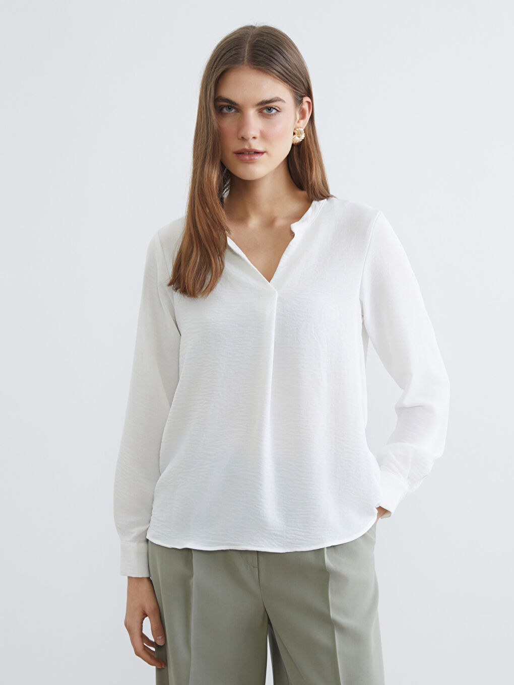 Textured blouse with an asymmetrical neckline.