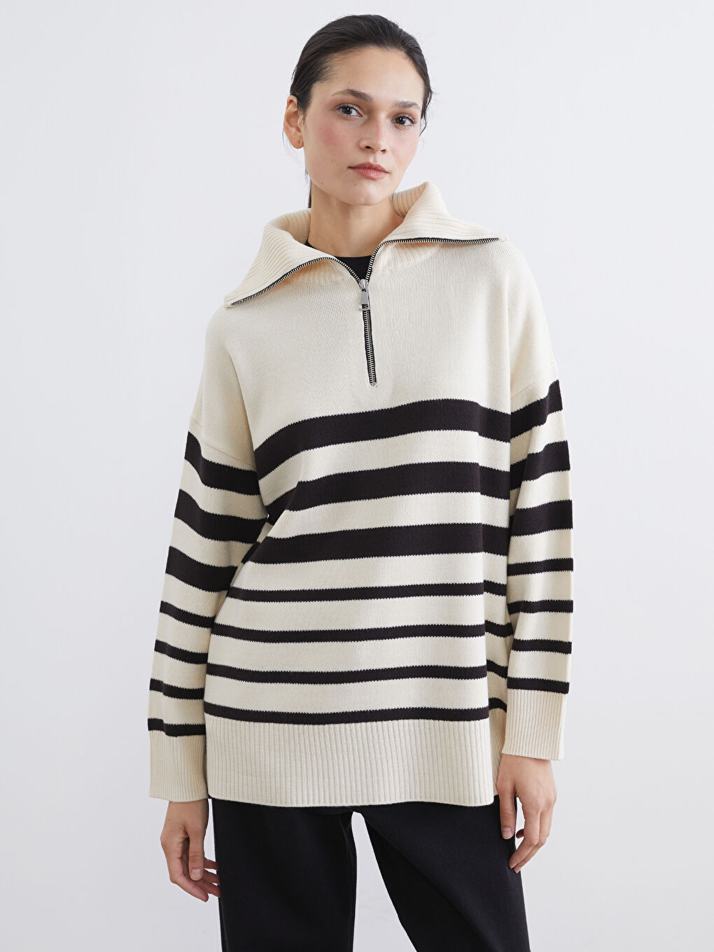 Striped oversized knit tunic with a stand-up collar.