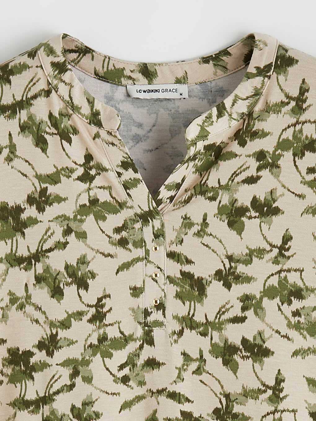 Floral blouse with an asymmetrical neckline.-4