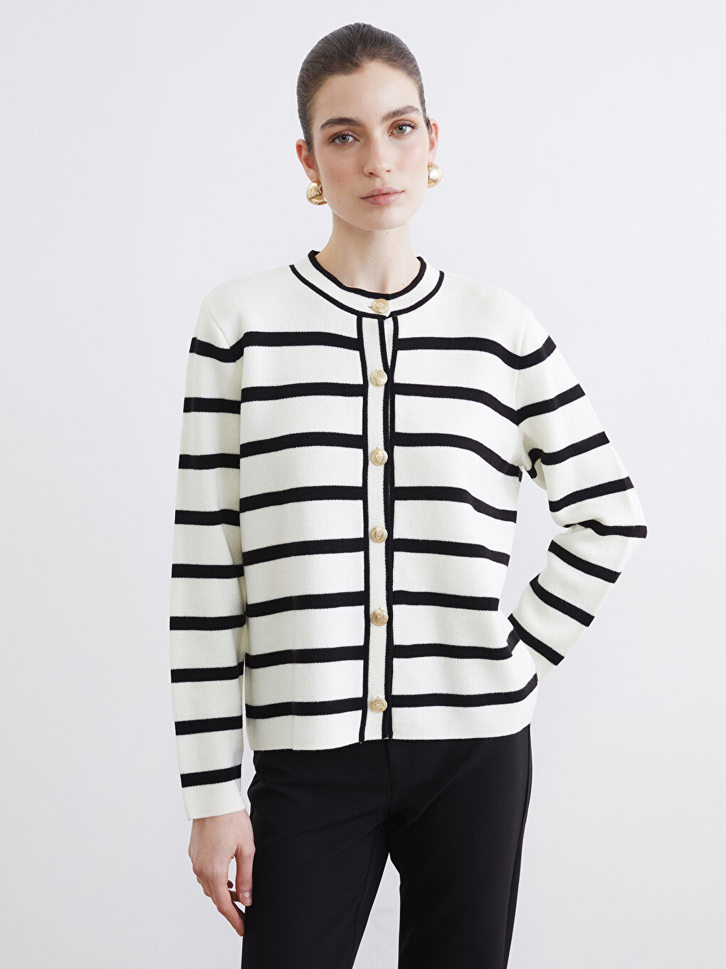 Striped knit cardigan with a round neckline.