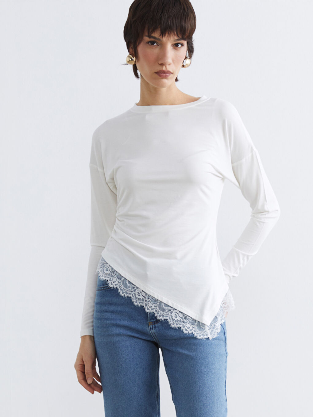 Embrace effortless charm with our lace-detailed, gathered blouse, featuring a classic crew neckline.